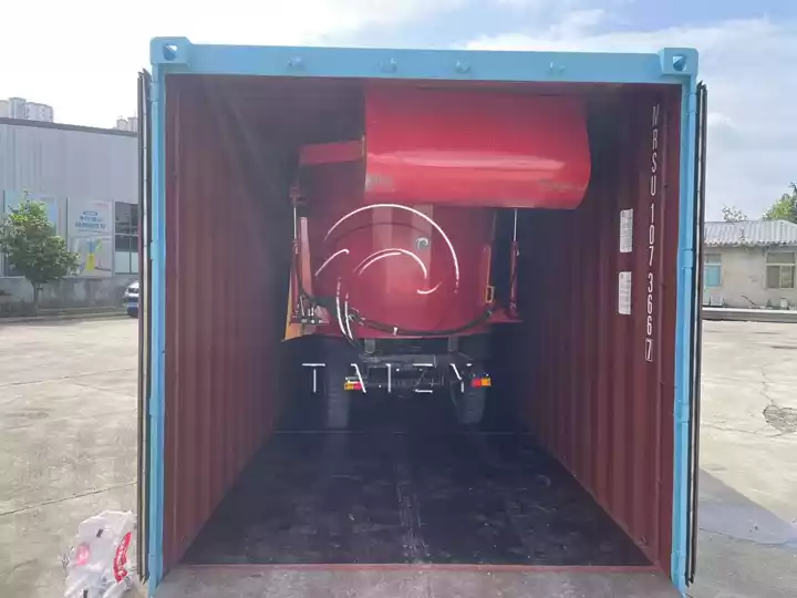 loading TMR silage spreader into container